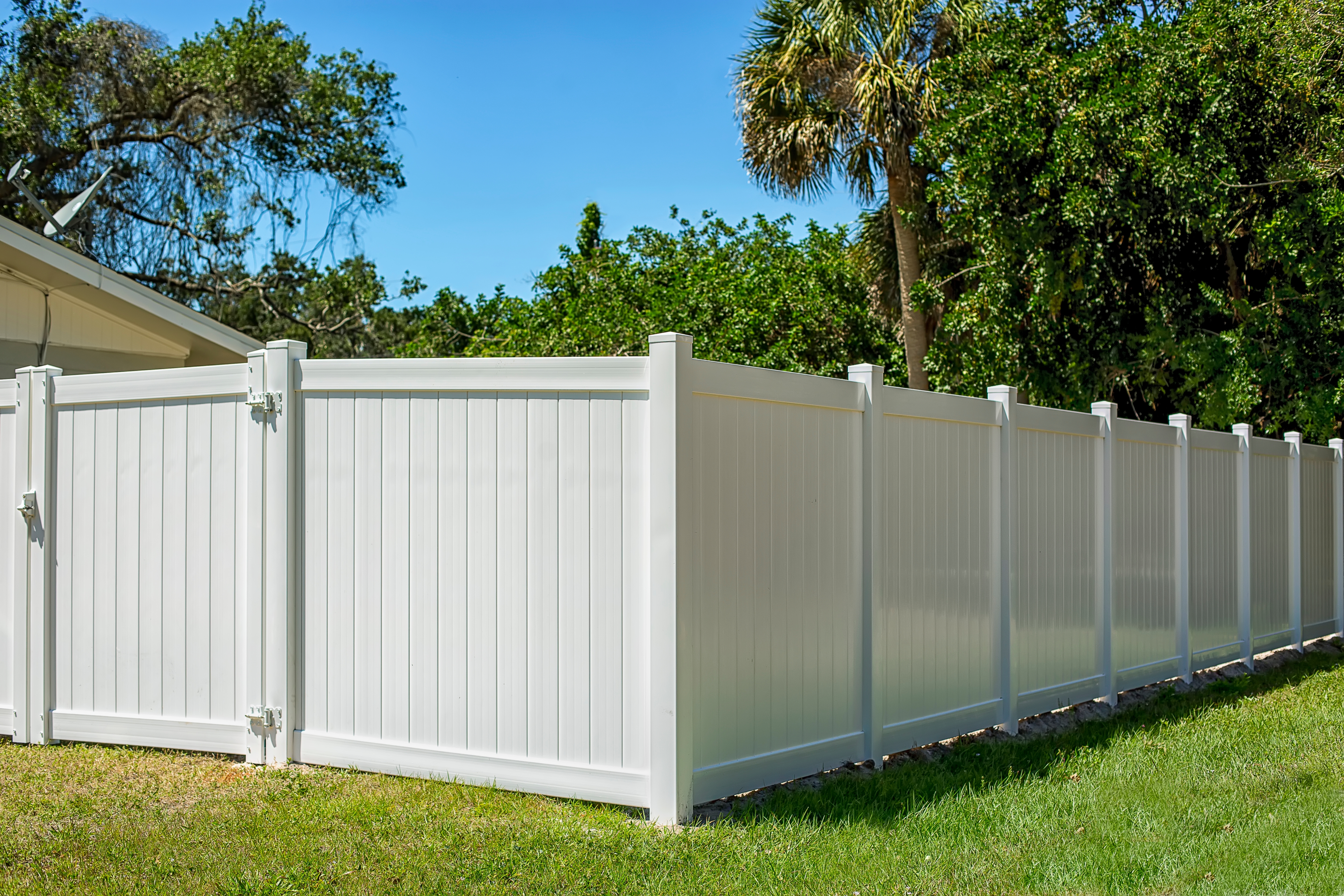White fencing installation in residential backyard providing privacy Tauranga